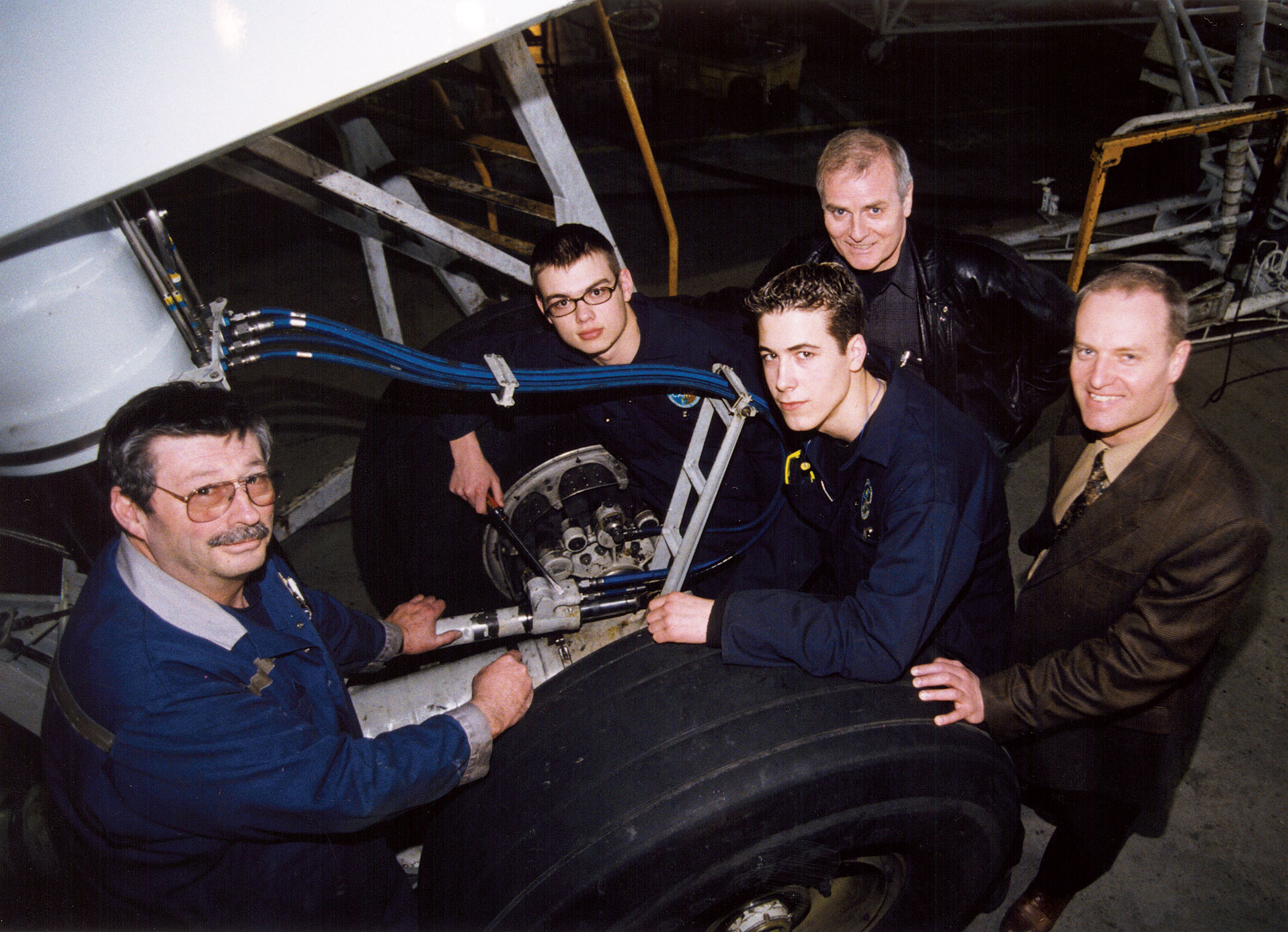 A photo of a group of young interns with their instructor and CEOs.