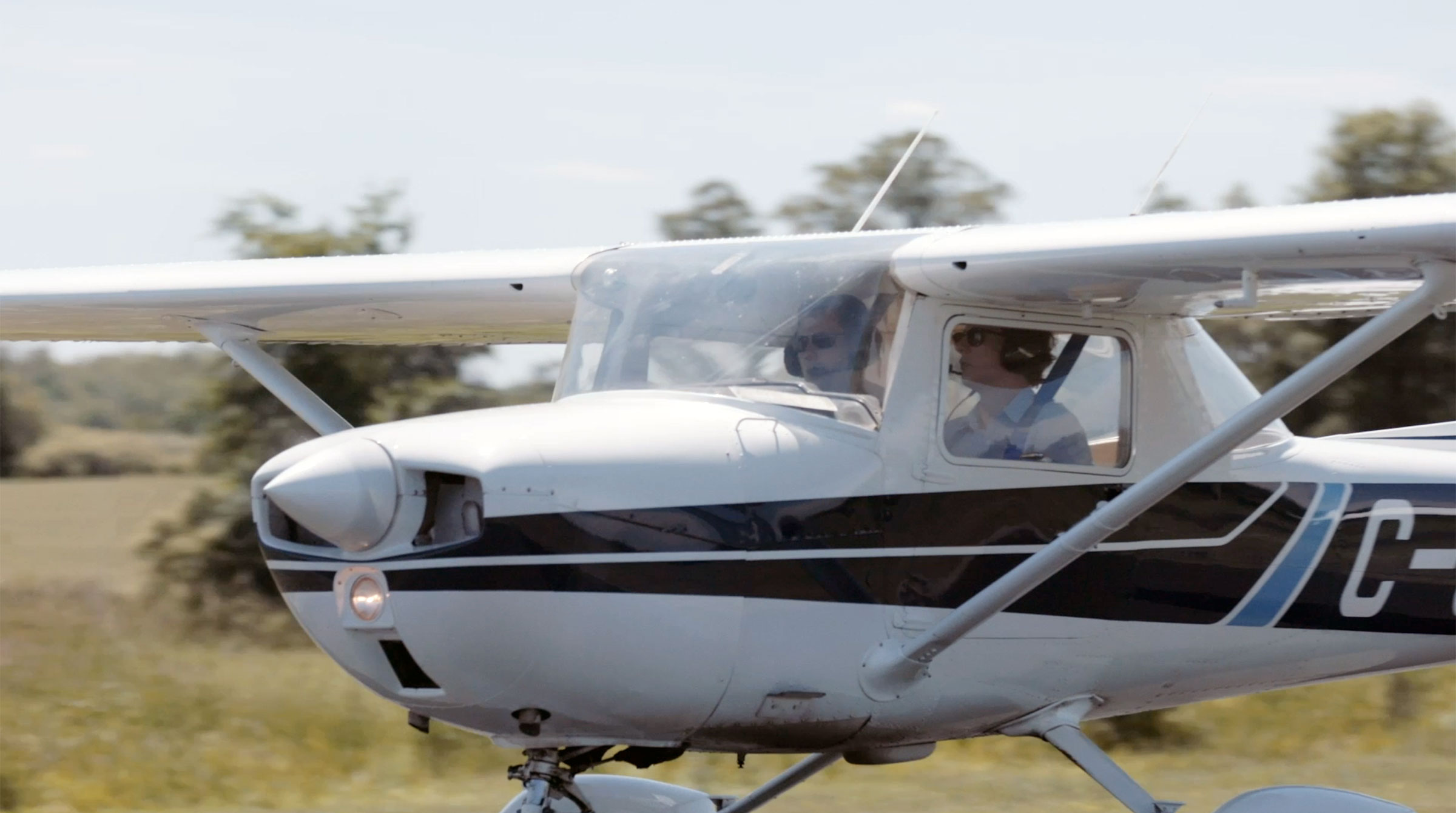 A picture of a student training with an employer inside a small plane.